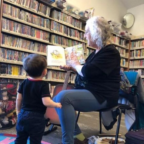 older woman reading to young boy