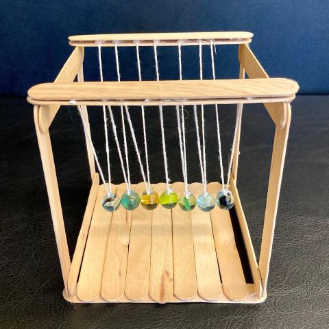 Popsicle sticks, string and marbles construction