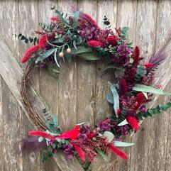 holiday wreath made from artificial red and green plants