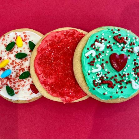 sugar cookies decorated with sprinkles and candy holiday light bulbs