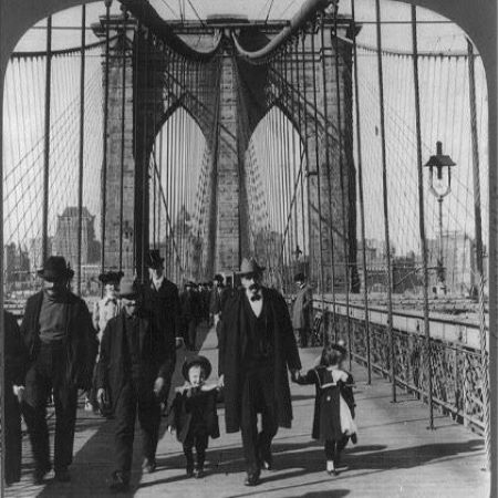 photo of people waling on the Brooklyn Bridge in the late 1800s