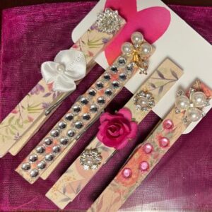 clothespins decorated with silk flowers and jewels