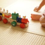toy train being pulled by a child's hand