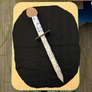 cardboard sword laying on a table