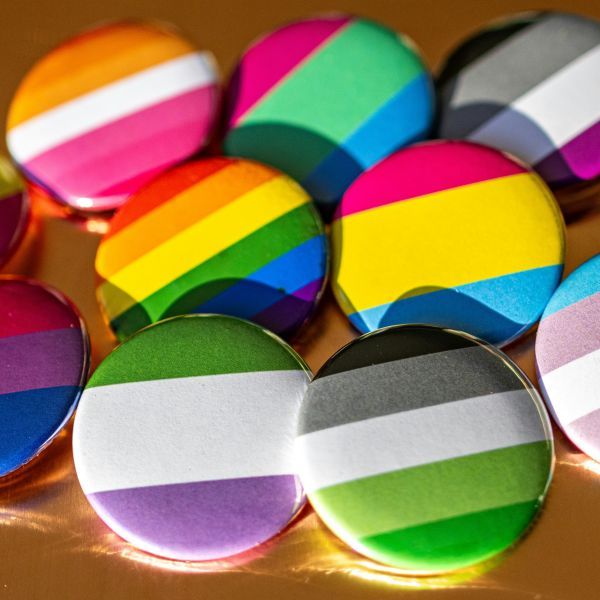 a collection of pastel striped campaign-style buttons