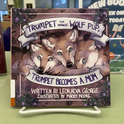 Book cover titled Trumpet Becomes a Mom, underneath illustration of three wolf pups