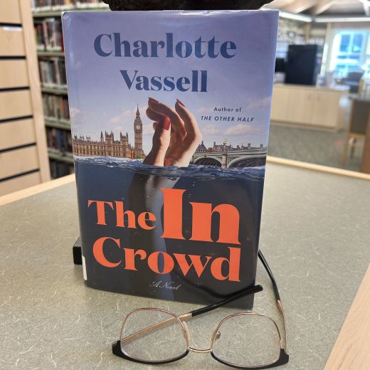 A book with title "The In Crowd" and an image of a hand rising from the water, alongside a pair of reading glasses.