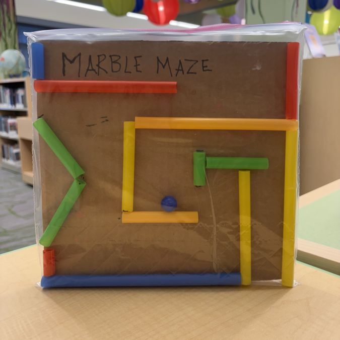 maze made from cardboard base, with straws as the walls of the maze
