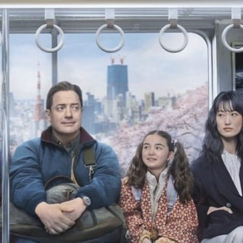 small girl seated on subway between a man and a woman