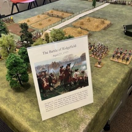 Table with signage saying Battle of Ridgefield, on miniature battlefield complete with trees, fields and soldiers