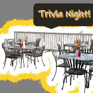 glass tables on patio beneath words Trivia Night!