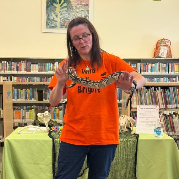 Woman holds a snake in her hands