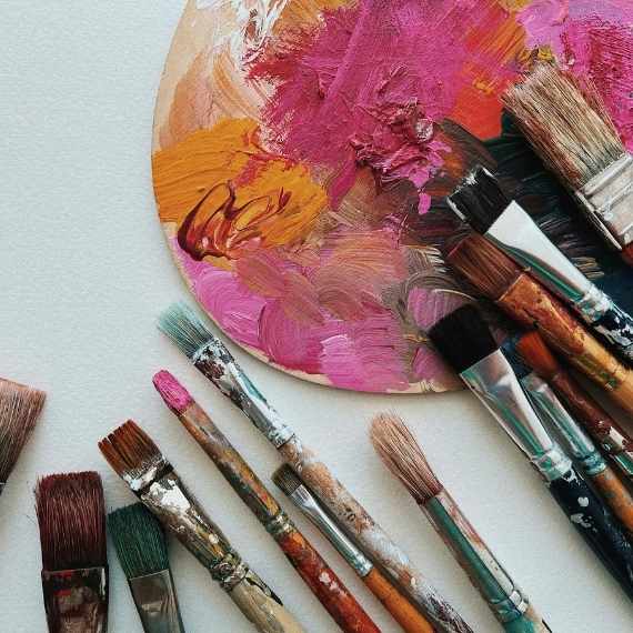 Brushes and a paint palette on a table.