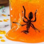 Fake ant suspended in orange slime.