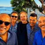 Cartoon image of five men in front of a beach