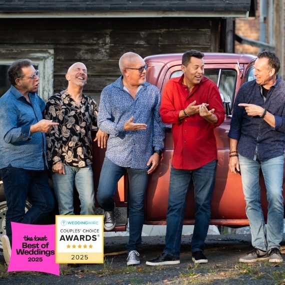 Five men standing in front of a red pick up truck.