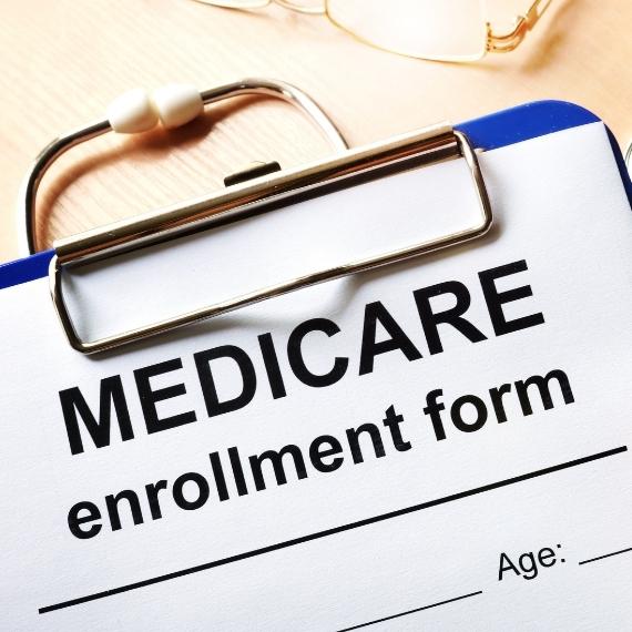 A clipboard with a paper titled Medicare enrollment form