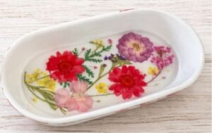 White tray decorated with pressed flowers