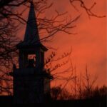 Silhouette of a tower in front of a red sky