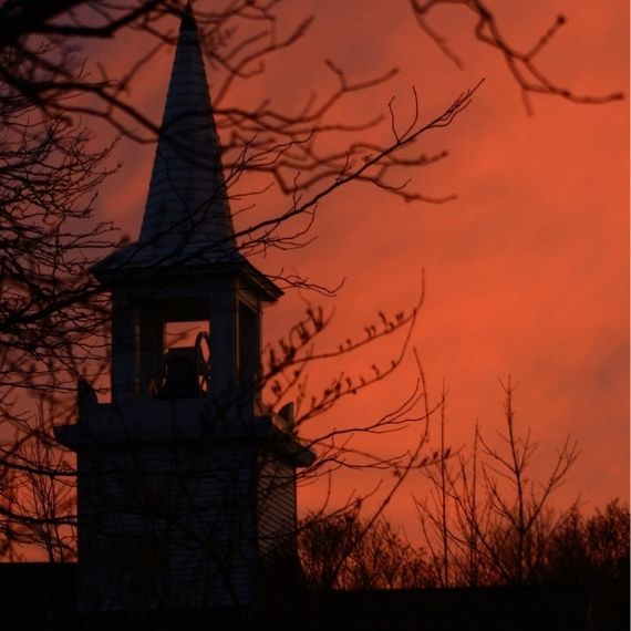 Silhouette of a tower in front of a red sky