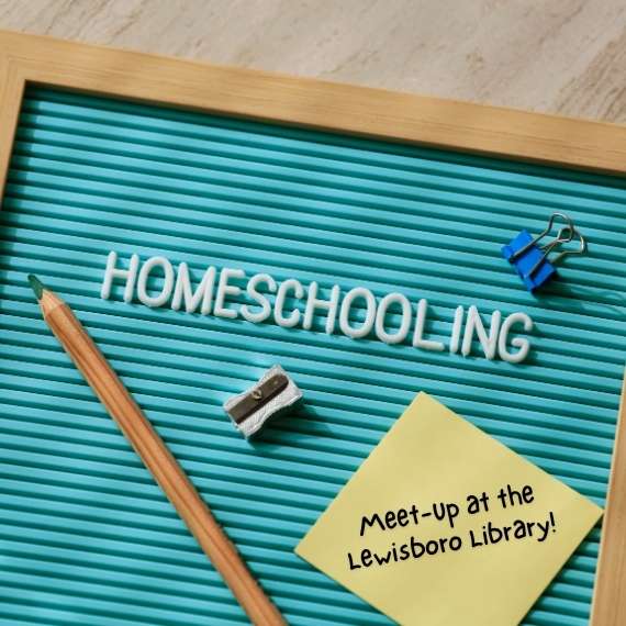 Letter board with word "Homeschooling" spelled with letters and a sticky note with words "Meet-up at the Lewisboro Library"