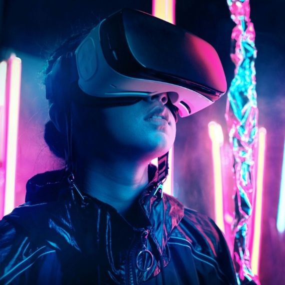Person wearing VR glasses in neon lighting